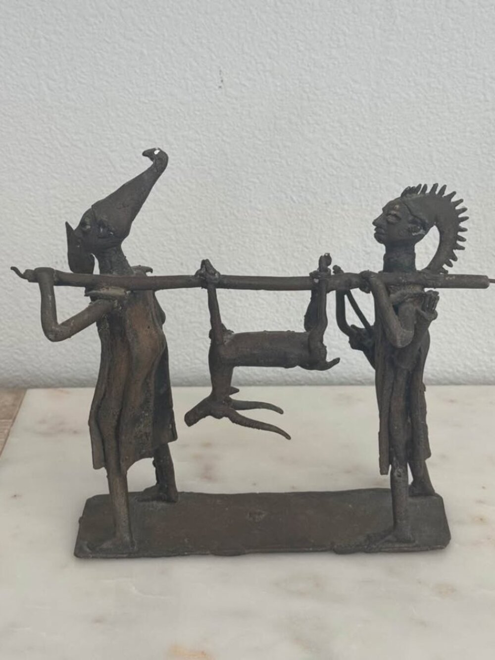 Antique Brass Sculpture of Tribal Men carrying a hunted antelope suspended from